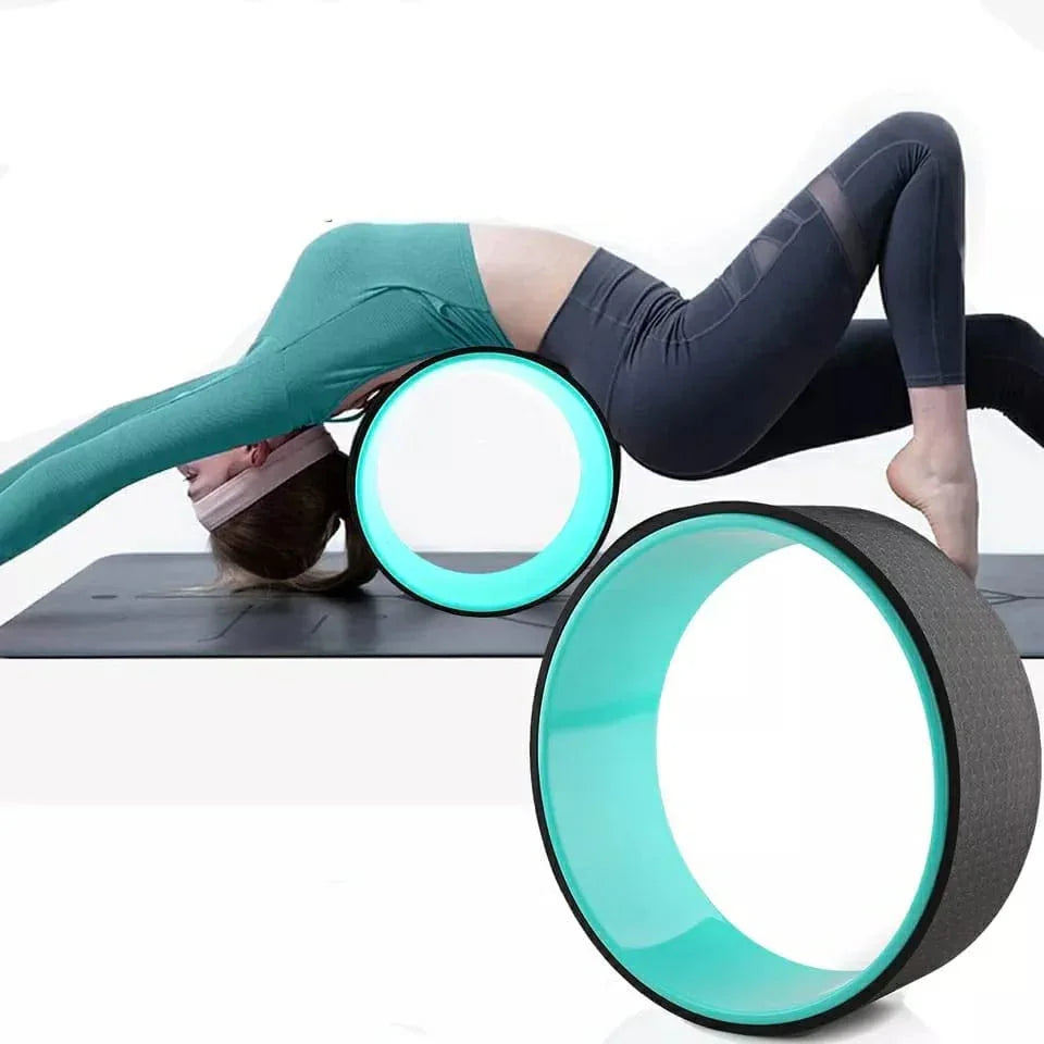 Woman using yoga wheel for back stretching on exercise mat, SportQ fitness equipment