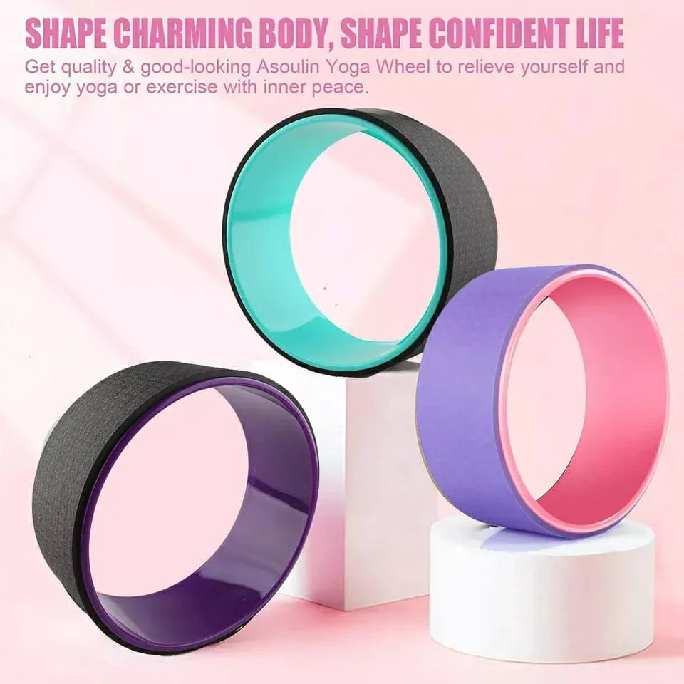 Colorful yoga wheels for exercise and stretching, displayed on a pink background at SportQ.