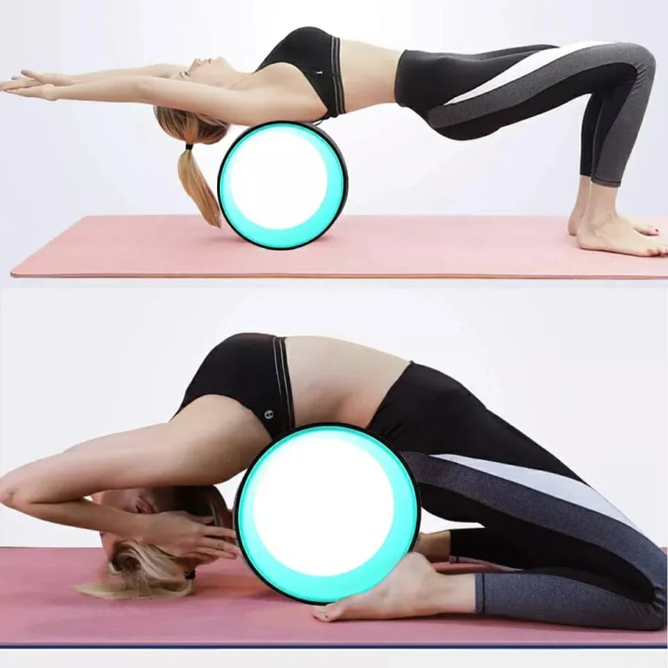 Woman using yoga wheel for stretching exercises on pink mat, SportQ Egypt fitness equipment