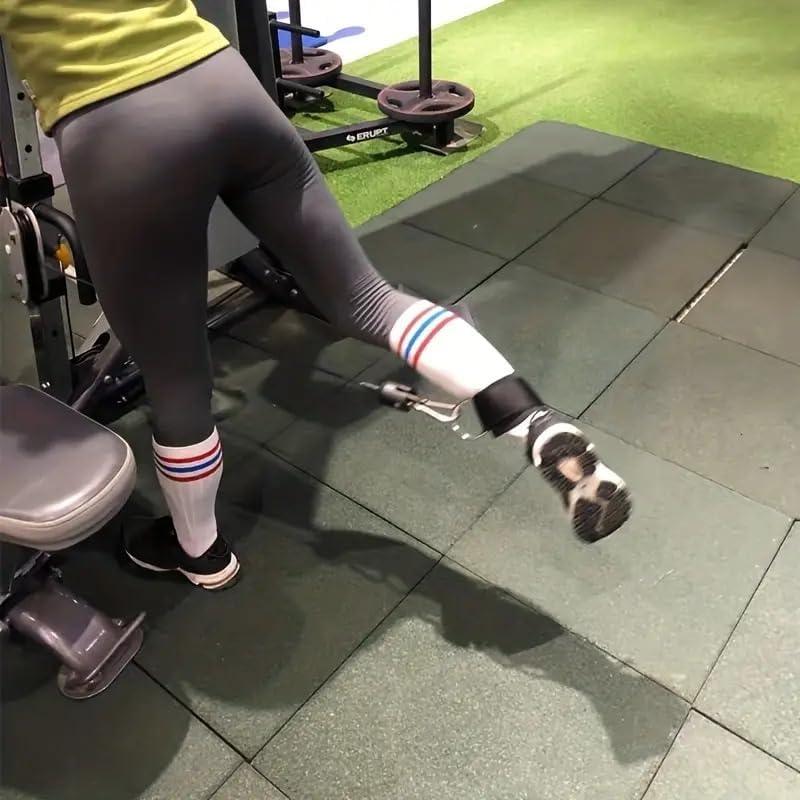 Woman using ankle strap cable attachment for leg workout in gym, SportQ fitness equipment